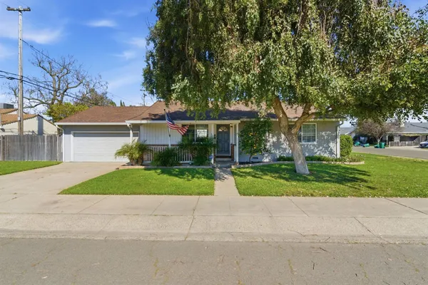 a front view of house with yard and green space