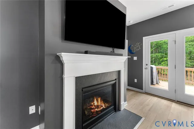 a living room with a fireplace a flat screen tv and a fireplace