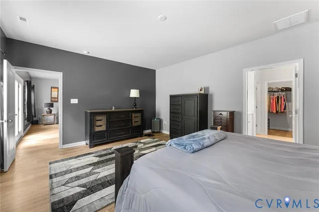 a bedroom with a bed and a mirror