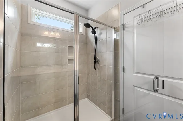 a bathroom with a shower and a glass door shower
