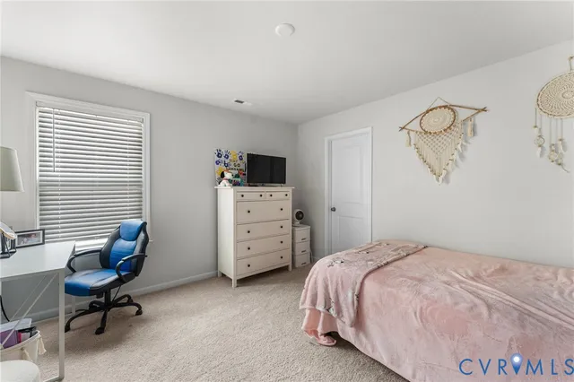 a bedroom with a bed and a desk