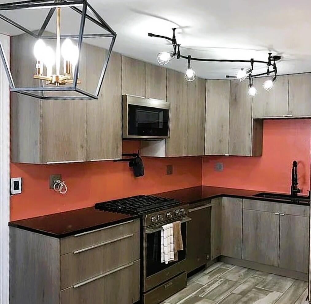 2698 County Line Road Lake Station, IN 46405 - Photo 6 of 22 a kitchen with stainless steel appliances granite countertop a sink a stove and a refrigerator