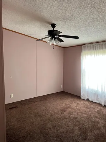 a view of a chandelier fan and closet in a room