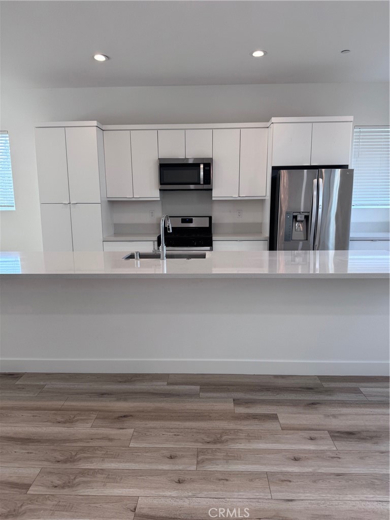 438 Hudson Street Brea, CA 92821 - Photo 12 of 29 a kitchen with stainless steel appliances cabinets and wooden floor