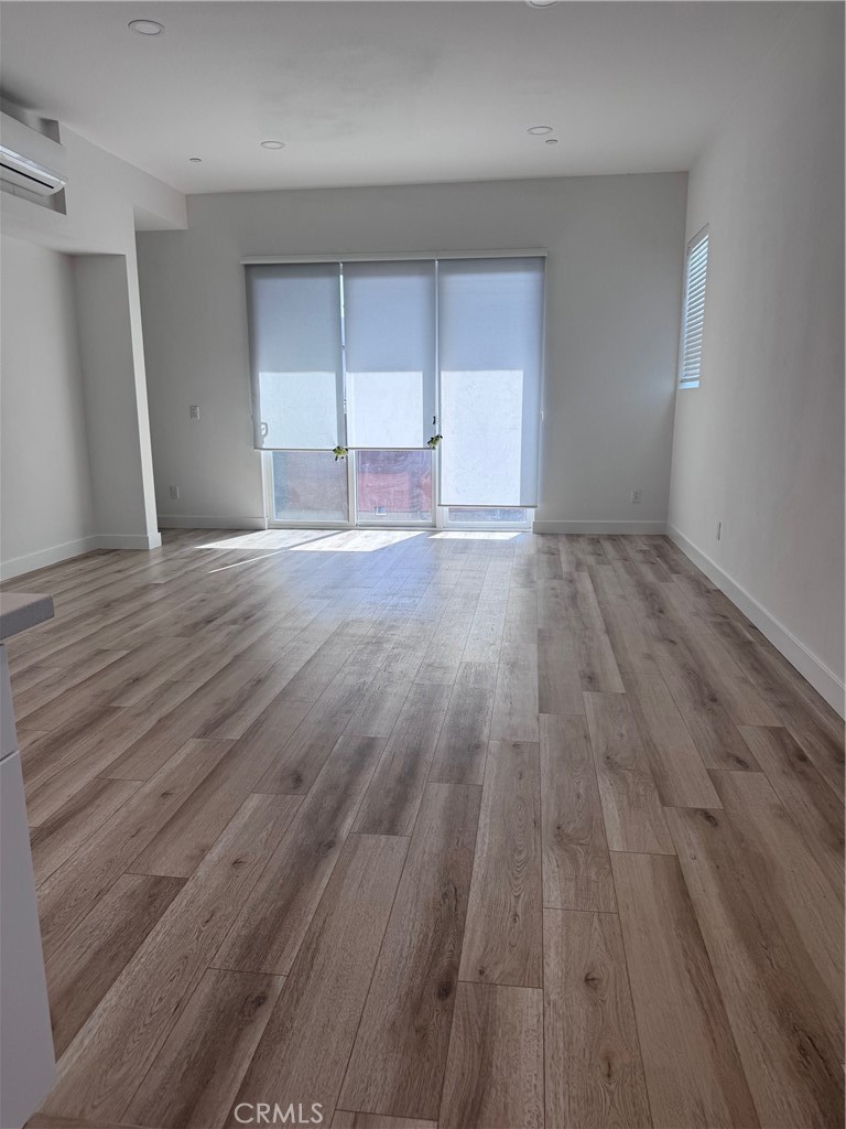 438 Hudson Street Brea, CA 92821 - Photo 15 of 29 wooden floor in an empty room with a window