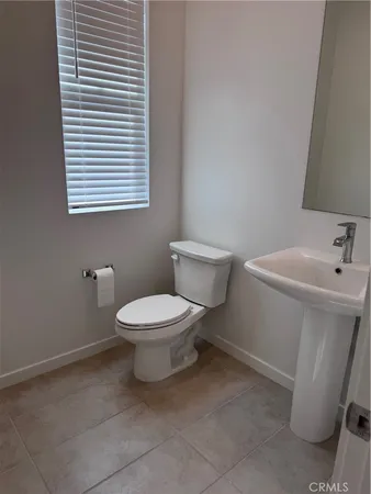 a white toilet sitting next to a bathroom sink