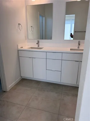 a bathroom with a sink vanity and mirror