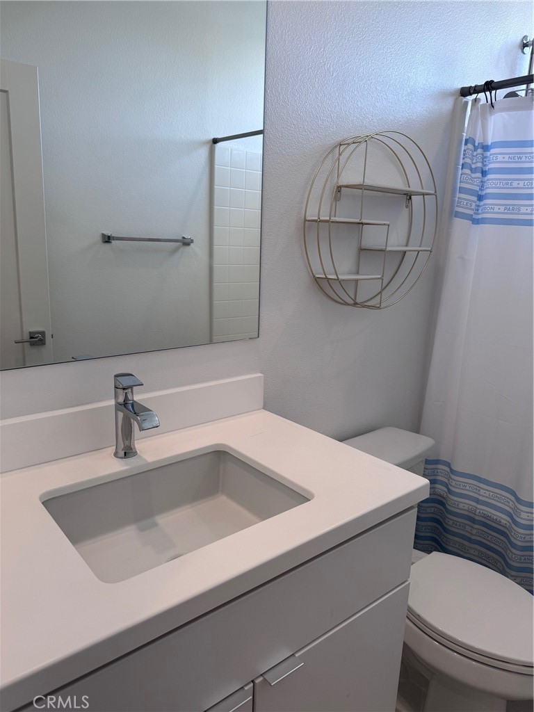438 Hudson Street Brea, CA 92821 - Photo 29 of 29 a bathroom with a sink a toilet and a mirror