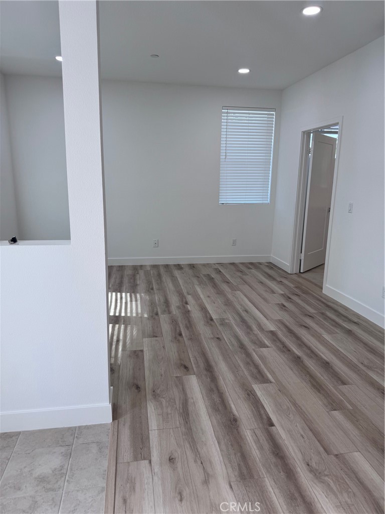 438 Hudson Street Brea, CA 92821 - Photo 3 of 29 a view of an empty room with wooden floor and a window