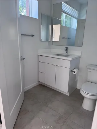 a bathroom with a sink toilet and mirror