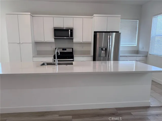 a kitchen with a refrigerator and a stove