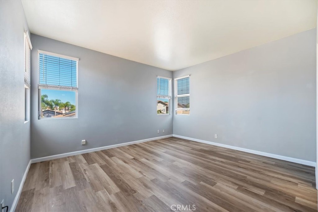 39557 Warbler Drive Temecula, CA 92591 - Photo 18 of 30 PRIMARY BEDROOM~ New baseboards & laminate flooring! Lots of windows-blinds included.