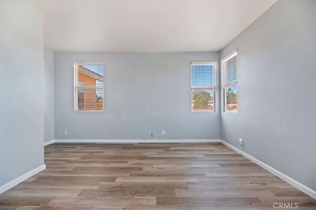 39557 Warbler Drive Temecula, CA 92591 - Photo 19 of 30 PRIMARY BEDROOM~ Large windows show off the new baseboards and flooring!
