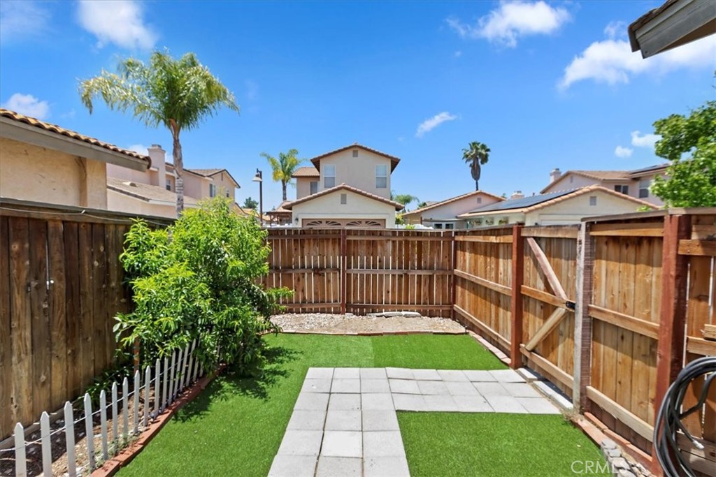 39557 Warbler Drive Temecula, CA 92591 - Photo 23 of 30 Backyard w/ easy care turf & some newer fencing to back driveway~