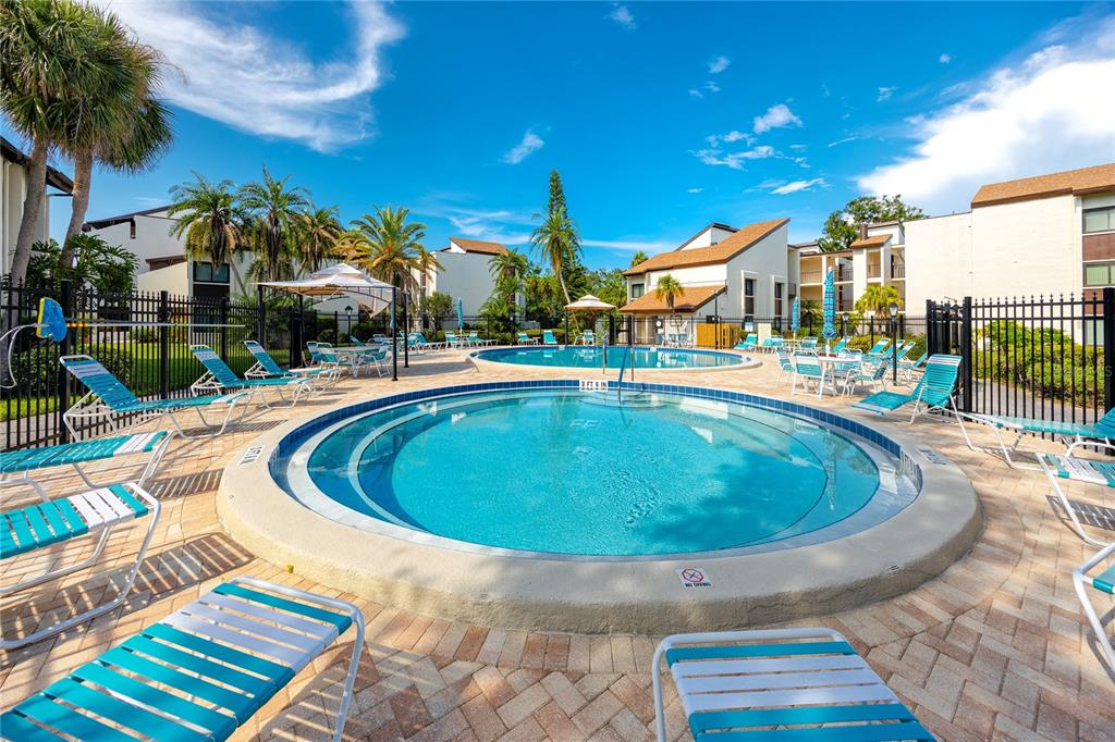 2207 Belleair Road, Unit B4 Clearwater, FL 33764 - Photo 2 of 37 a view of a swimming pool with a patio