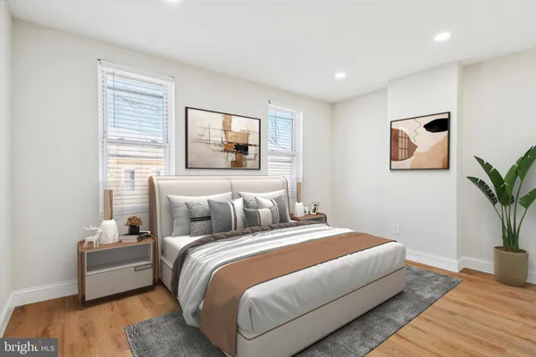 a bedroom with bed and a potted plant