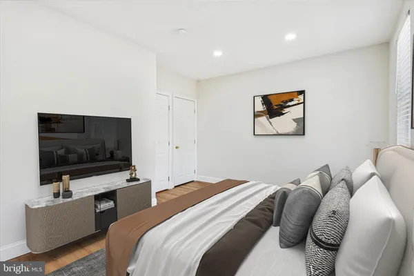 a bedroom with a bed and a flat screen tv