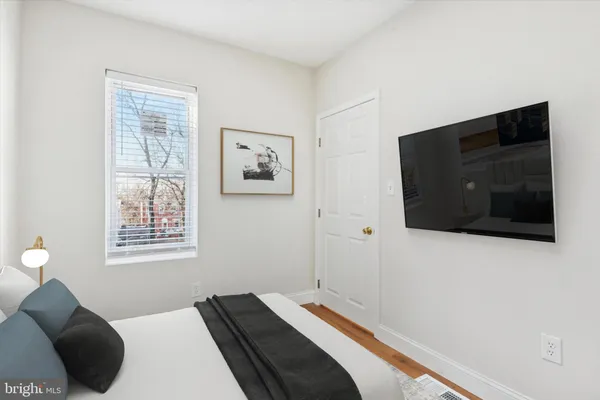 a bedroom with a bed and a flat screen tv