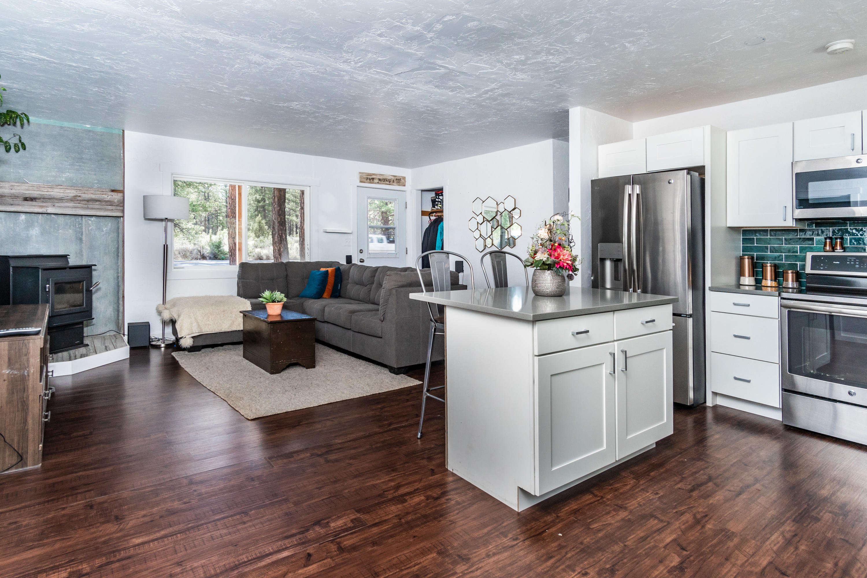60193 Cheyenne Road Bend, OR 97702 - Photo 7 of 29 a kitchen with white cabinets and appliances