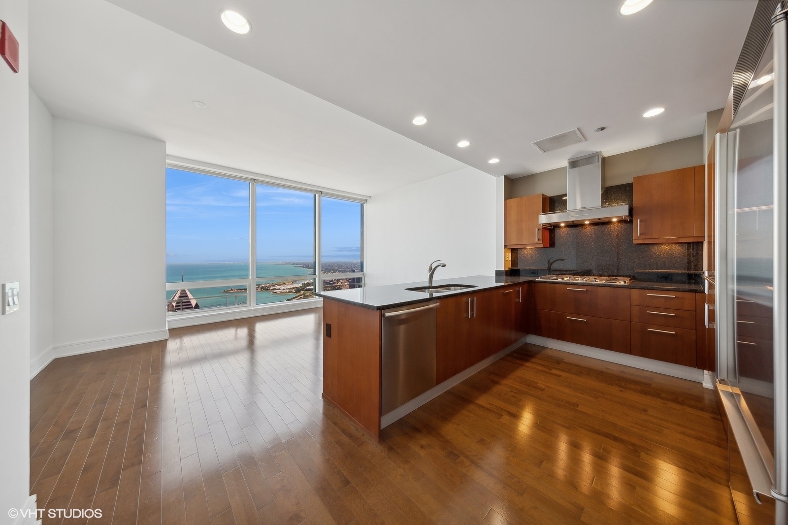 401 North Wabash Avenue, Unit 56B Chicago, IL 60611 - Photo 4 of 17 a kitchen with stainless steel appliances granite countertop a stove and a refrigerator