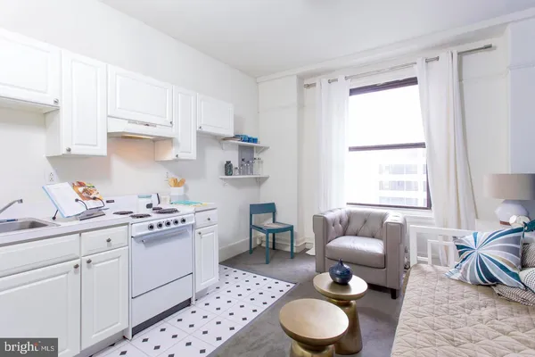 a kitchen with a sink stove and white cabinets