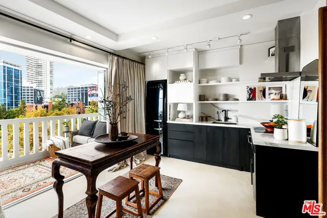 a kitchen with a refrigerator and a stove top oven