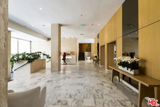 a lobby with a table and chairs