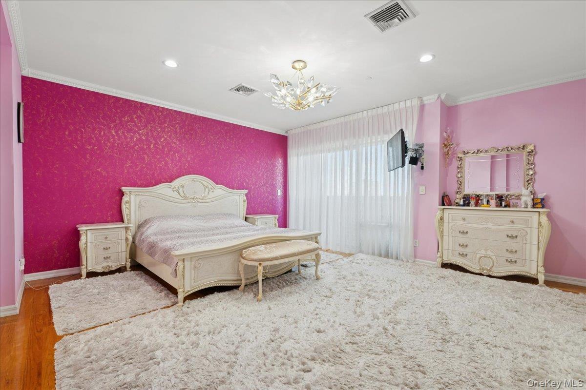 99-31 66th Avenue, Unit 7B Queens, NY 11374 - Photo 12 of 26 a living room with furniture and a chandelier