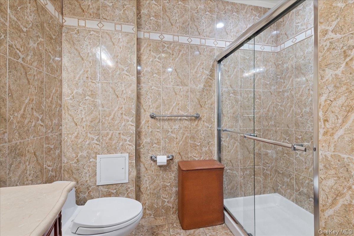 99-31 66th Avenue, Unit 7B Queens, NY 11374 - Photo 15 of 26 a toilet sitting next to a bathroom sink