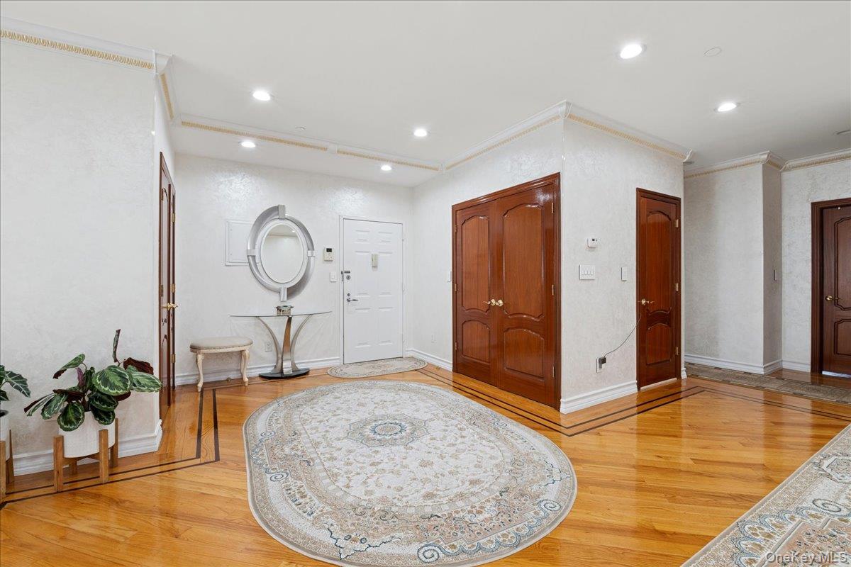 99-31 66th Avenue, Unit 7B Queens, NY 11374 - Photo 2 of 26 a view of a hallway with dining room and wooden floor