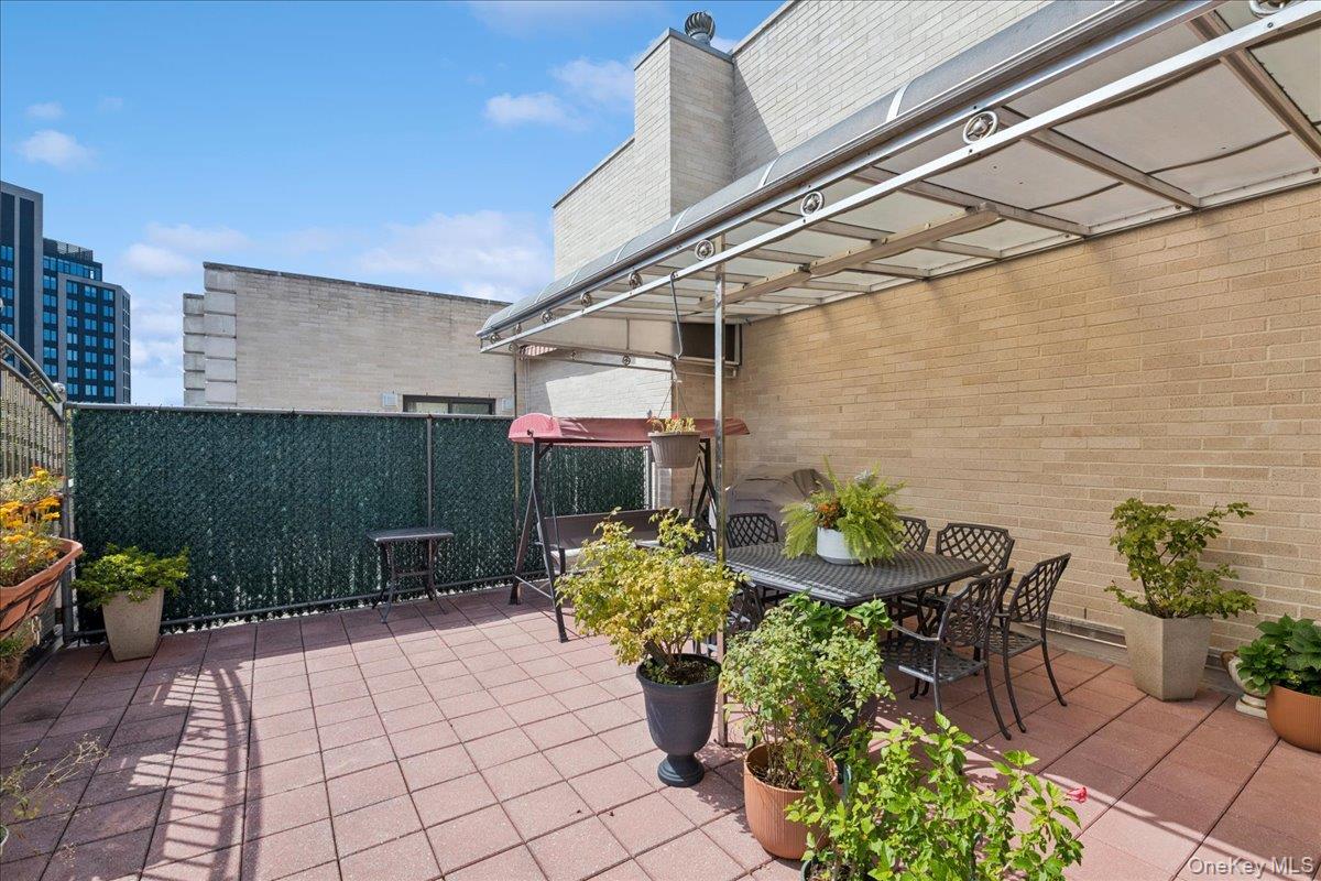 99-31 66th Avenue, Unit 7B Queens, NY 11374 - Photo 25 of 26 a view of a chairs and table in a patio