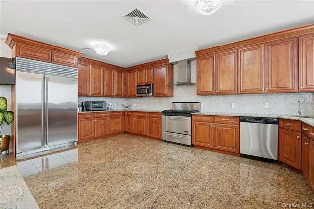 a kitchen with granite countertop a sink stainless steel appliances and cabinets