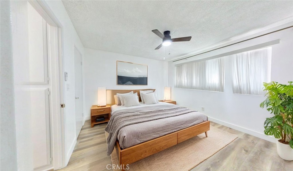 1648 Vía Mirada, Unit B Fullerton, CA 92833 - Photo 13 of 30 a bedroom with a bed chandelier and a window