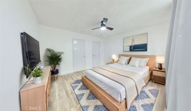 a bedroom with a bed and a potted plant