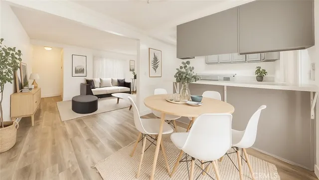 a dining room with furniture and wooden floor