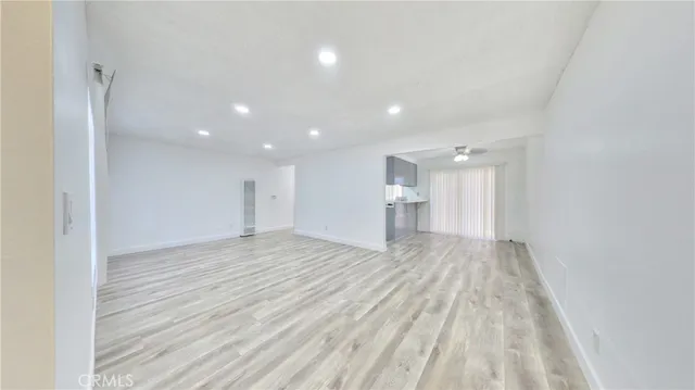 a view of empty room with wooden floor