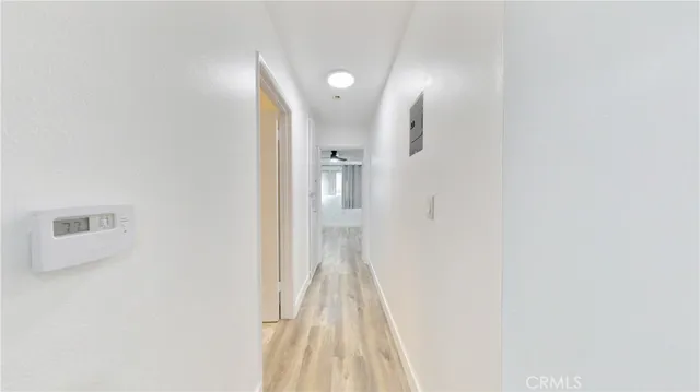 a view of a hallway with wooden floor