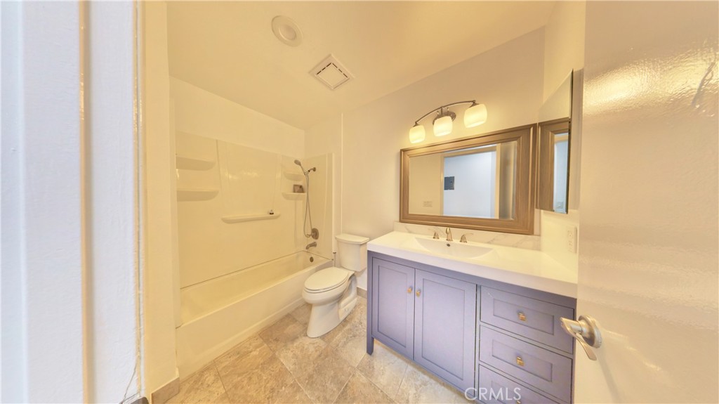1648 Vía Mirada, Unit B Fullerton, CA 92833 - Photo 25 of 30 a bathroom with a granite countertop sink toilet and shower