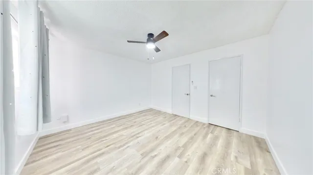 a view of empty room with ceiling fan