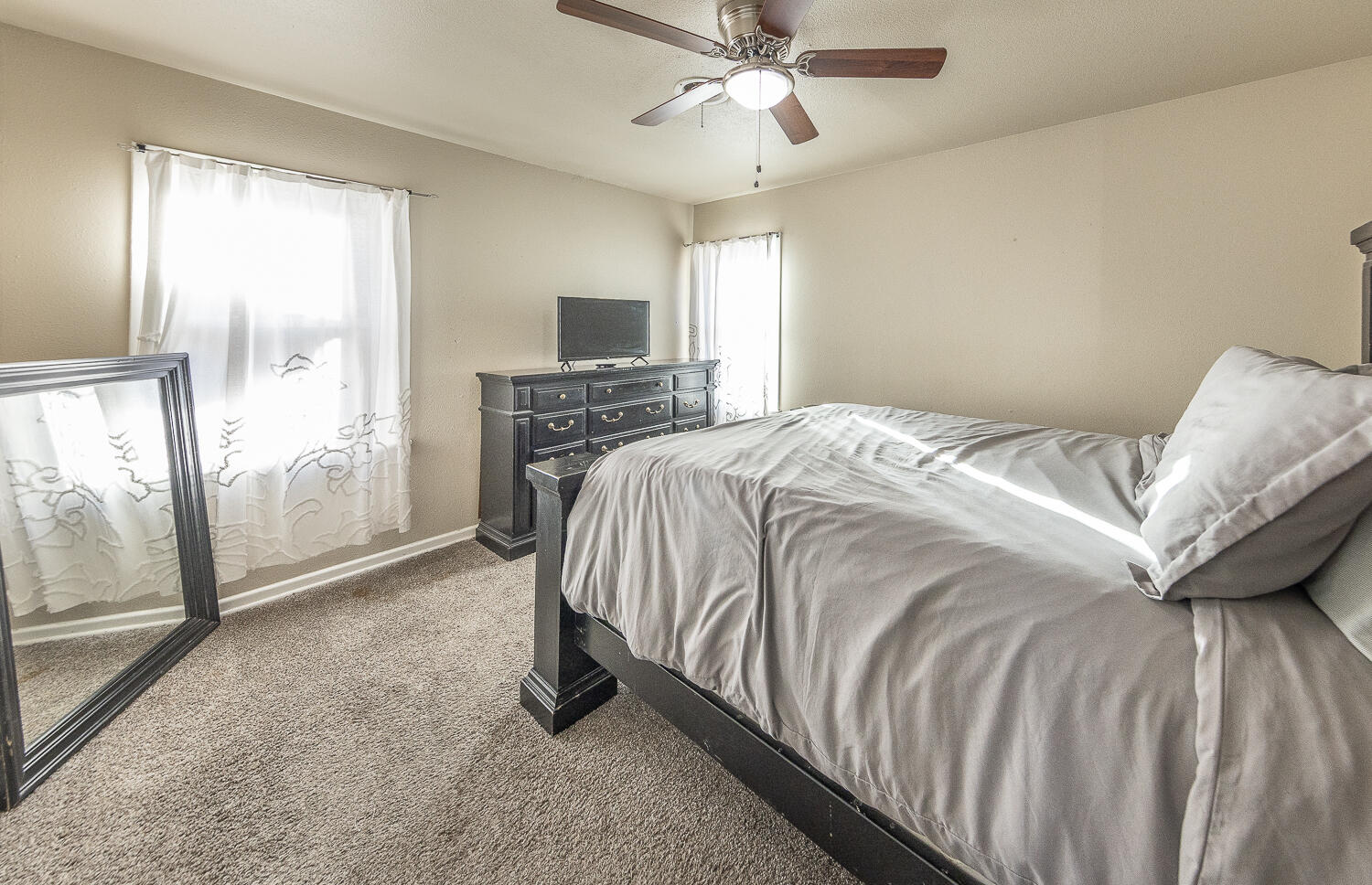 5109 44th Street Lubbock, TX 79414 - Photo 11 of 20 a spacious bedroom with a bed and glass door
