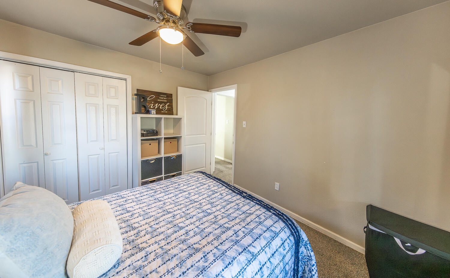 5109 44th Street Lubbock, TX 79414 - Photo 12 of 20 a bedroom with a bed and a chandelier fan