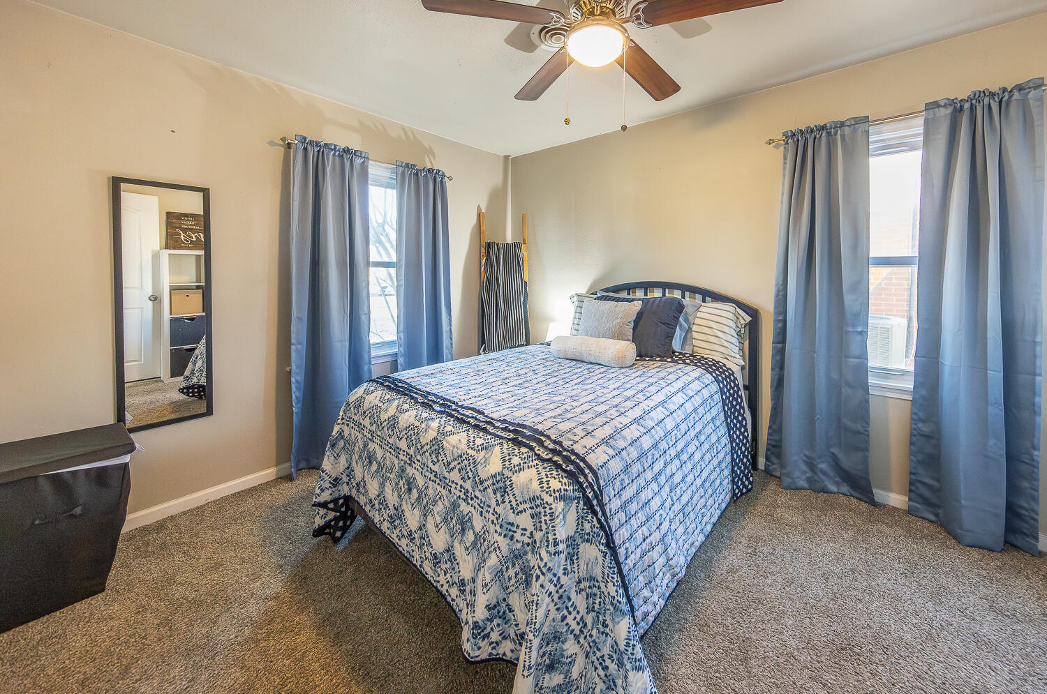 5109 44th Street Lubbock, TX 79414 - Photo 13 of 20 a bedroom with a large bed and a chandelier