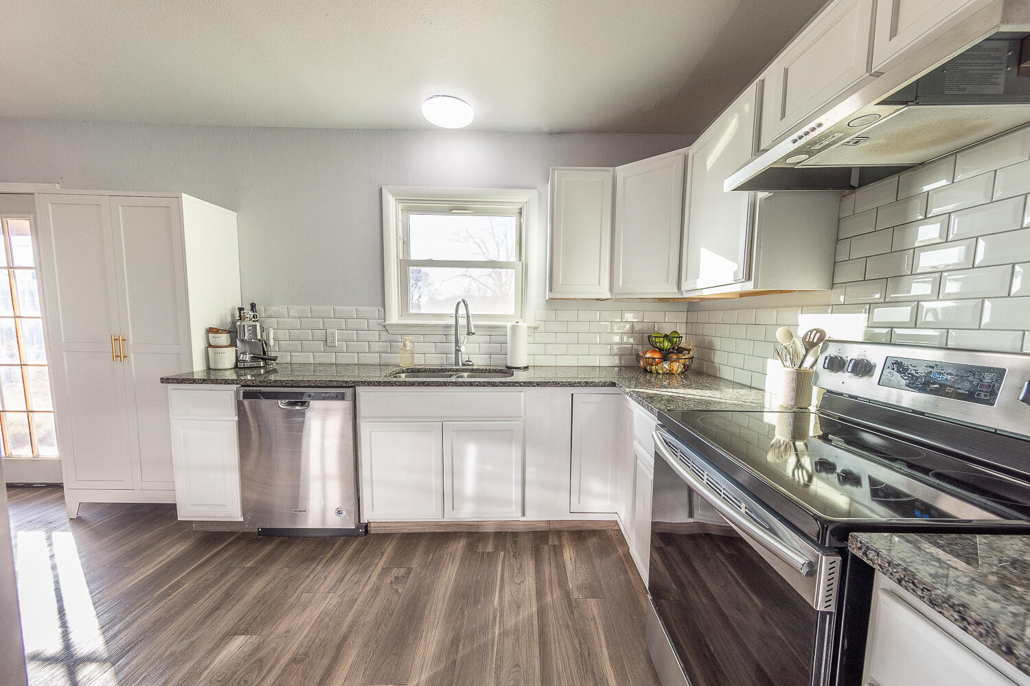 5109 44th Street Lubbock, TX 79414 - Photo 7 of 20 a kitchen with kitchen island granite countertop a sink cabinets and stainless steel appliances