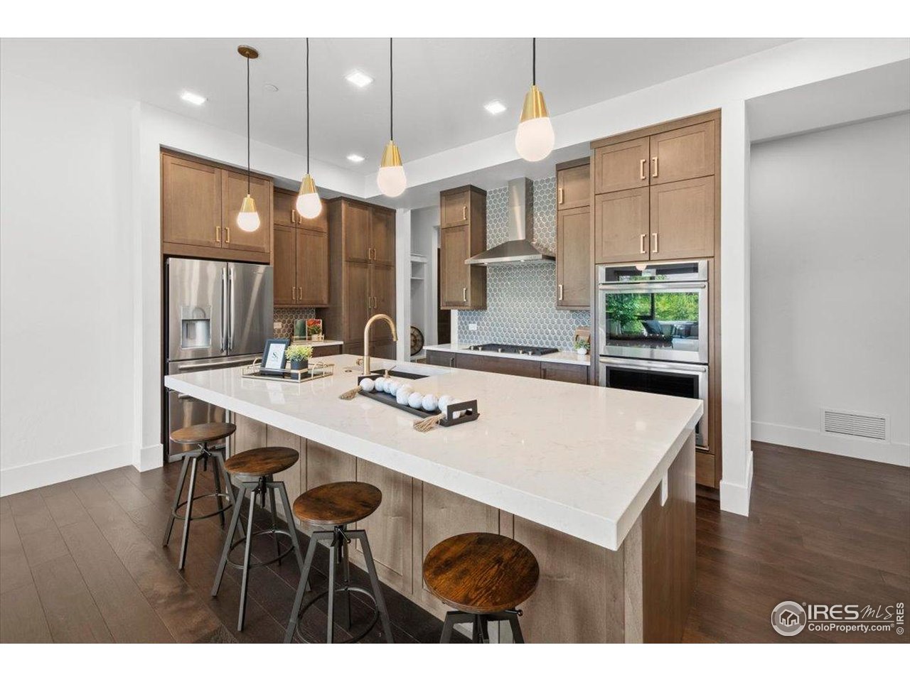 302 North Meldrum Street, Unit 313 Fort Collins, CO 80521 - Photo 12 of 38 a kitchen with kitchen island a stove a table and chairs