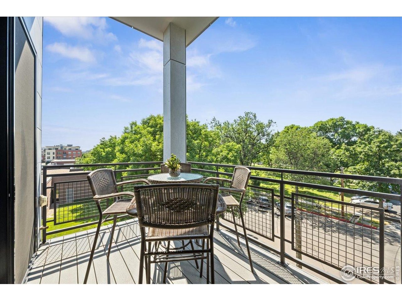 302 North Meldrum Street, Unit 313 Fort Collins, CO 80521 - Photo 14 of 38 a view of balcony with chairs and wooden fence