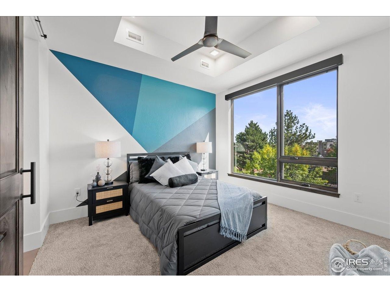 302 North Meldrum Street, Unit 313 Fort Collins, CO 80521 - Photo 19 of 38 a bedroom with furniture and a large window