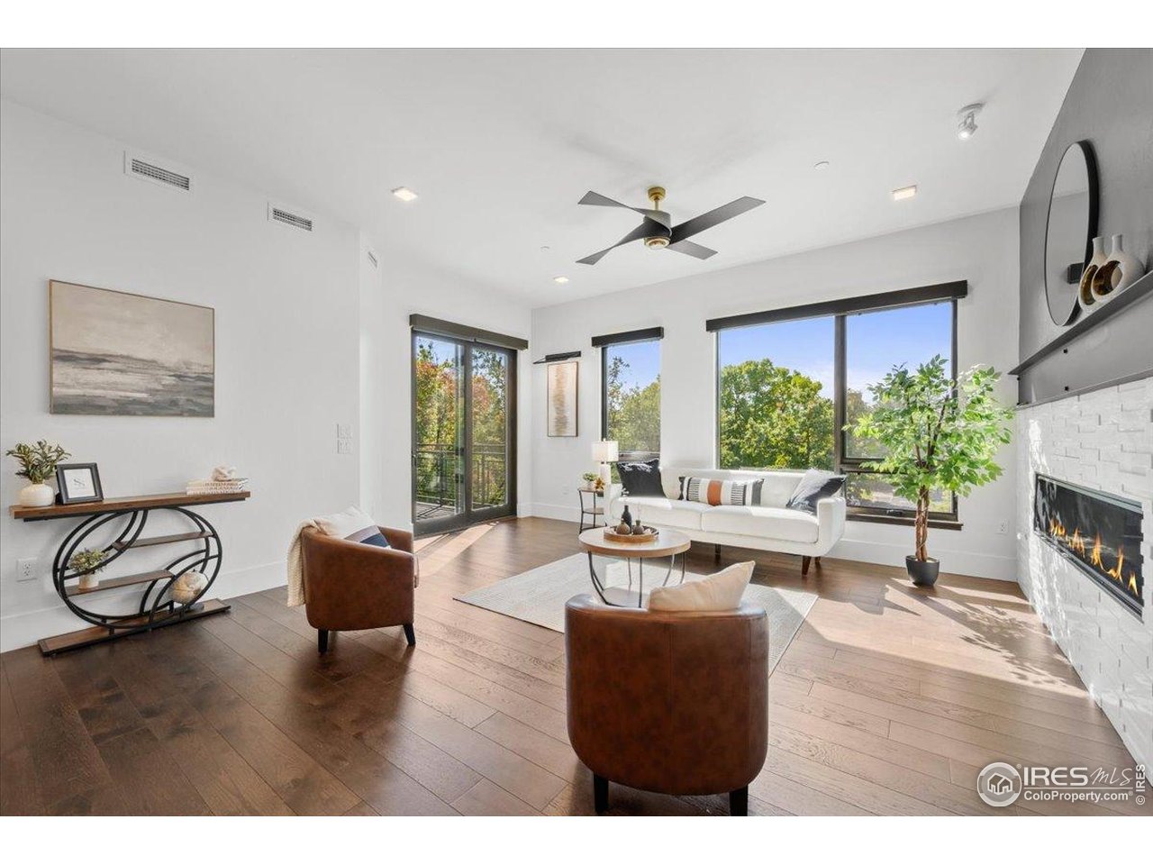 302 North Meldrum Street, Unit 313 Fort Collins, CO 80521 - Photo 2 of 38 a living room with furniture a fireplace and a large window