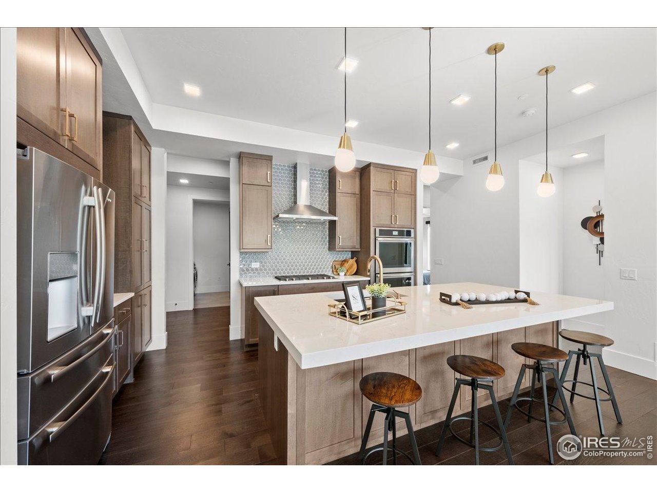 302 North Meldrum Street, Unit 313 Fort Collins, CO 80521 - Photo 6 of 38 a kitchen with granite countertop a table chairs stainless steel appliances and cabinets