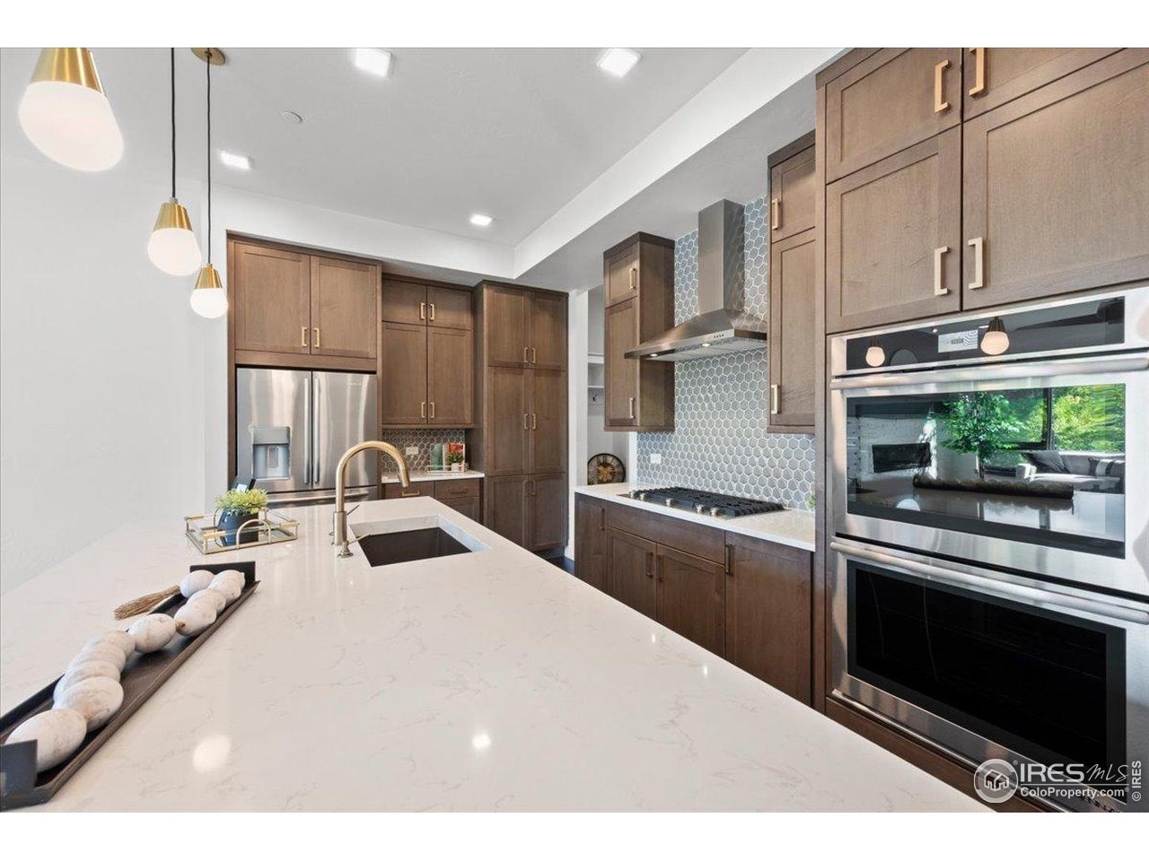 302 North Meldrum Street, Unit 313 Fort Collins, CO 80521 - Photo 7 of 38 a kitchen with kitchen island granite countertop a sink stainless steel appliances and cabinets