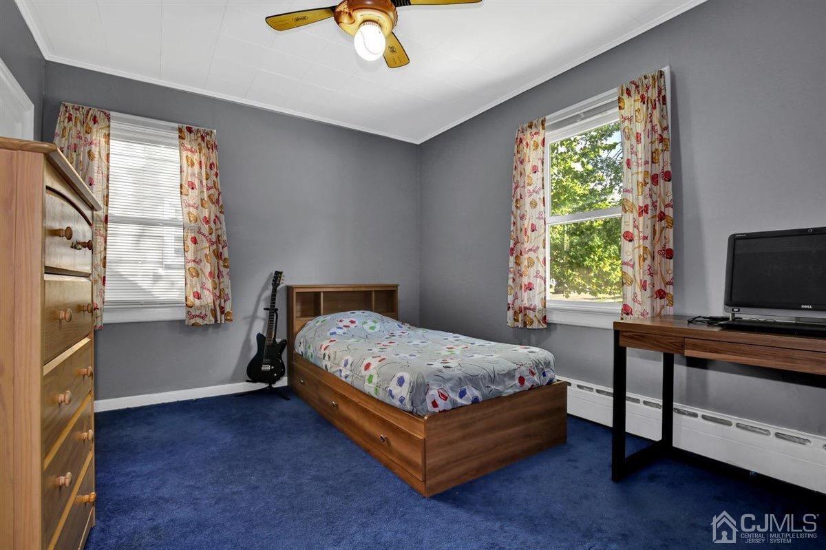 284 Old Post Road Edison, NJ 08817 - Photo 14 of 27 a bed sitting in a bedroom next to a window